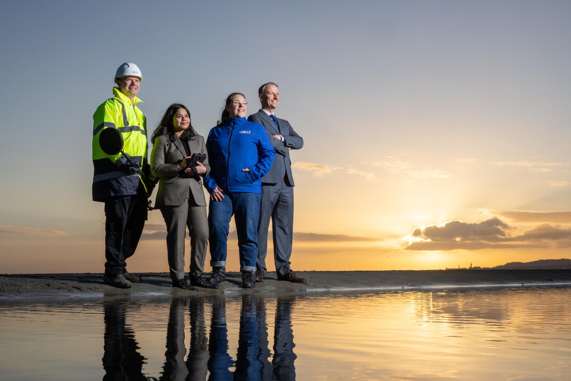 Four people on a beach
