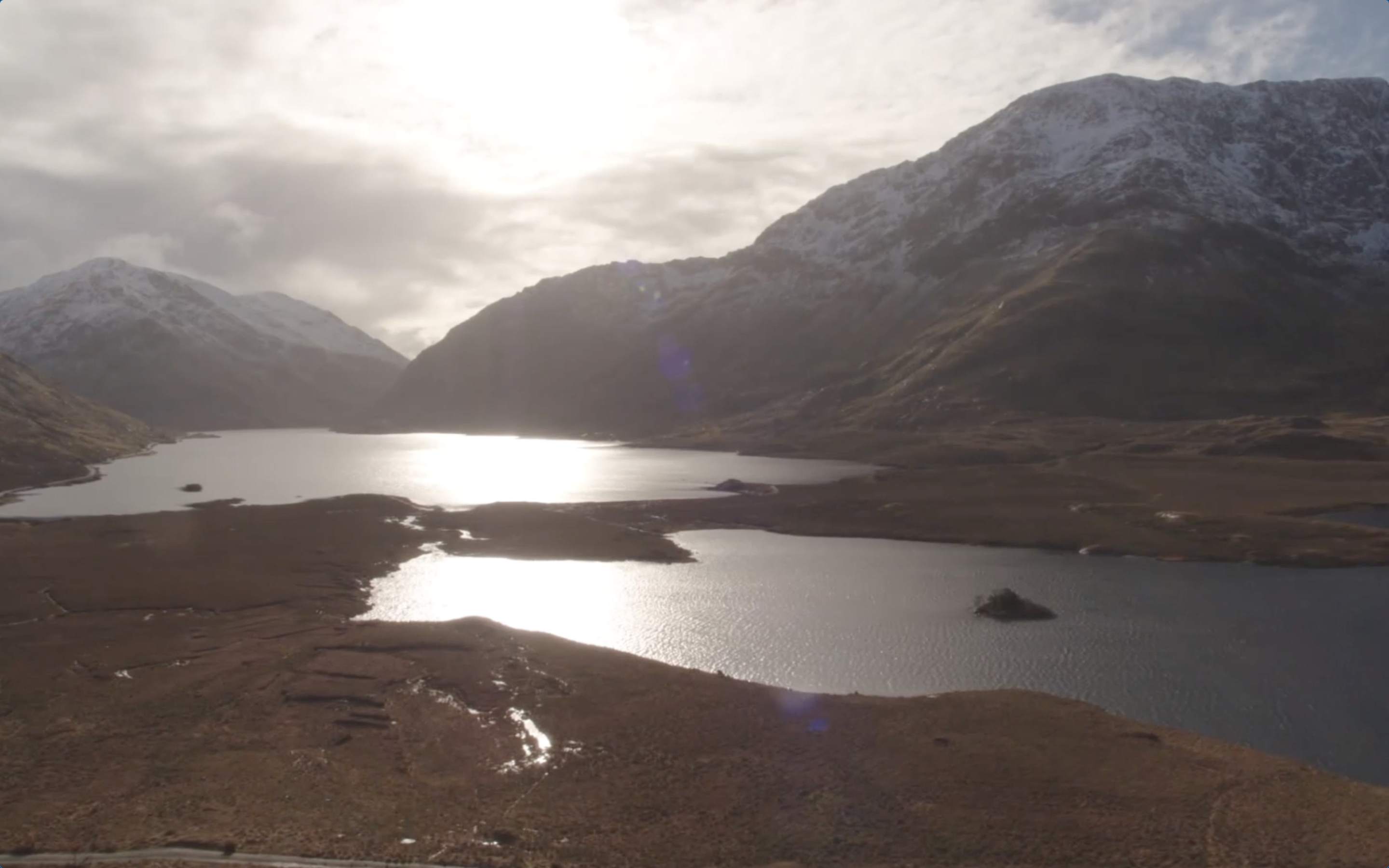Two lakes in a valley with mountains covered in snow
