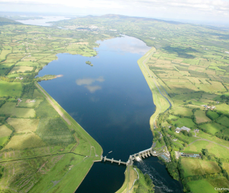 An aerial photo of a lake surrounded by fields 