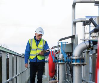 Uisce Éireann engineer onsite reading a book
