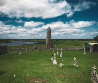 Graveyard with a round tower beside a lake