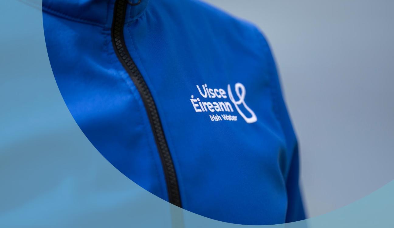 An Uisce Éireann employee wearing a blue zipped jacket